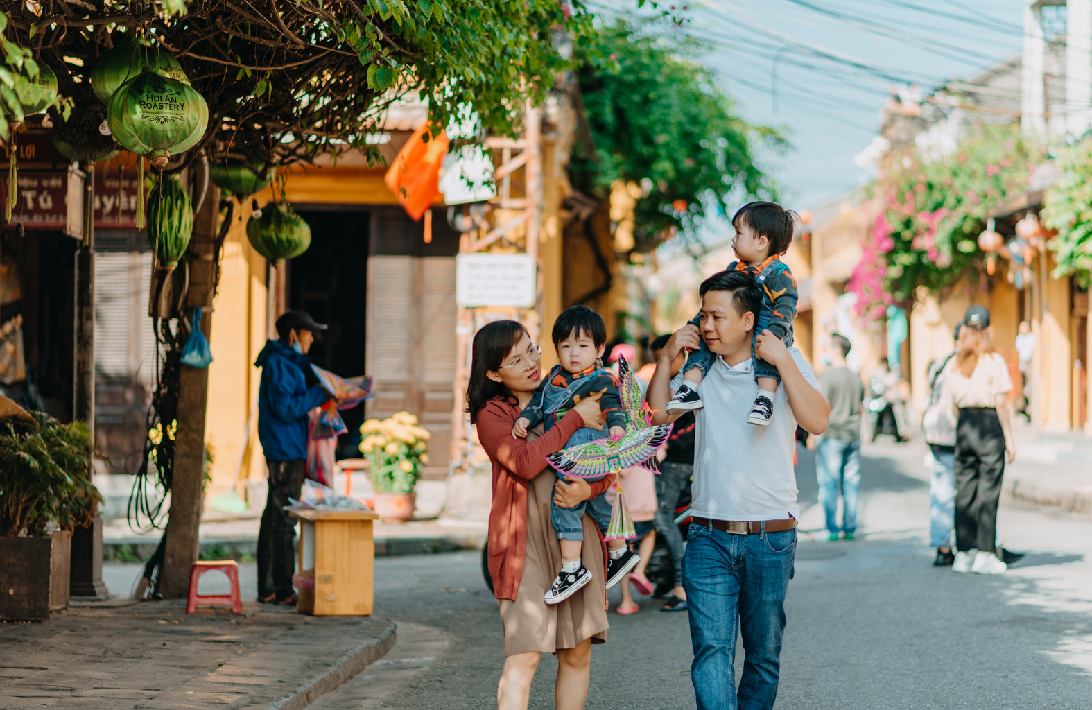 Asian parents with children walking on street